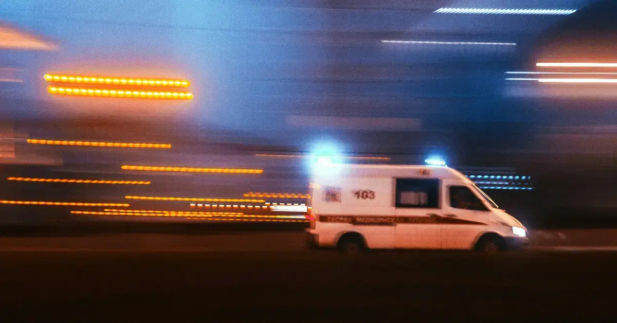 Blurred image of a moving ambulance at night with light trails, symbolizing dynamic benefit-risk evaluation