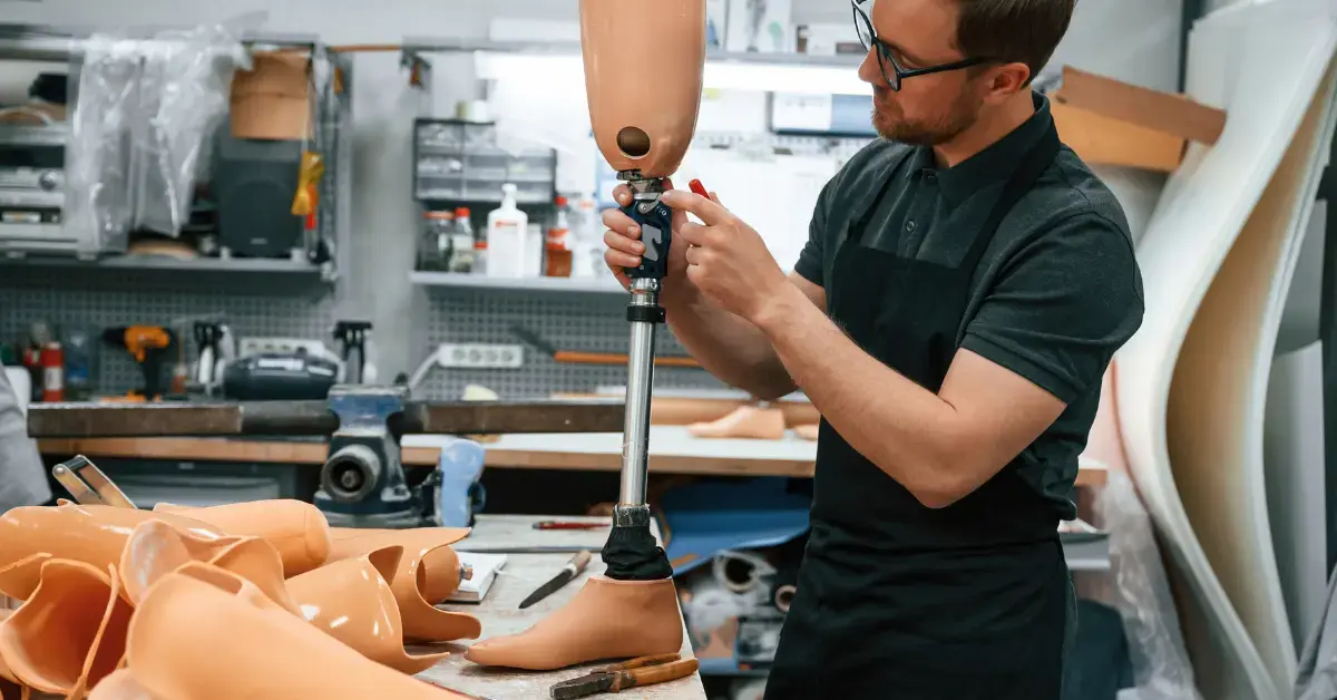 Techniker passt eine patientenspezifische Beinprothese an und fertigt ein maßgeschneidertes Medizinprodukt an